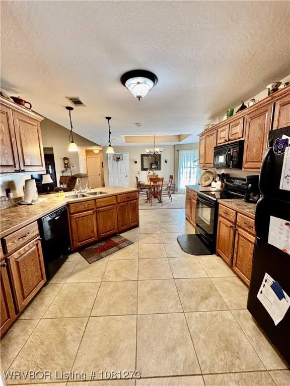 195 Polk 492, Cove, AR 71937 - kitchen with black appliances, light tile patterned floors, brown cabinets, a peninsula, and a sink