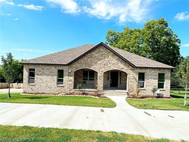 french country home with a front lawn and a porch