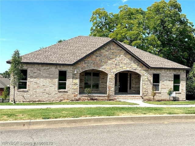 french provincial home featuring a porch