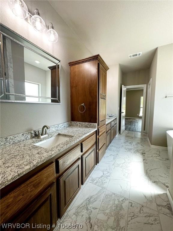 bathroom featuring a bathing tub and vanity