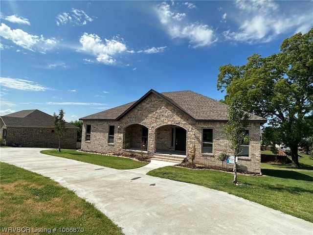 french country style house featuring a front lawn