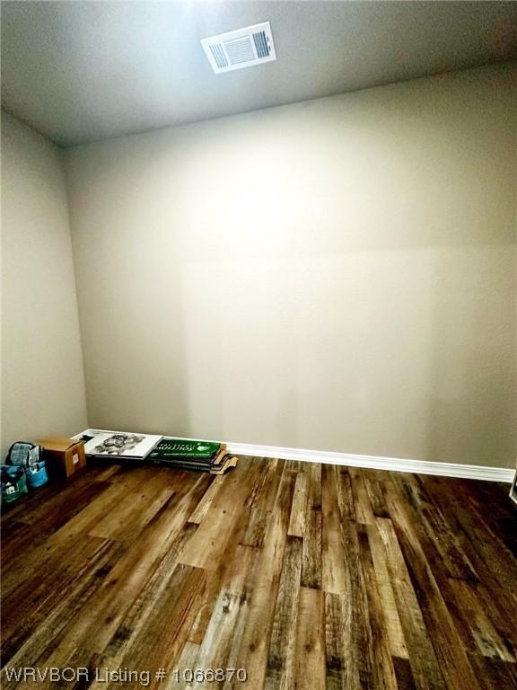 unfurnished room featuring dark wood-type flooring