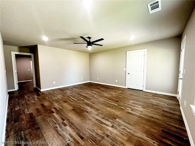 spare room with ceiling fan and dark hardwood / wood-style flooring