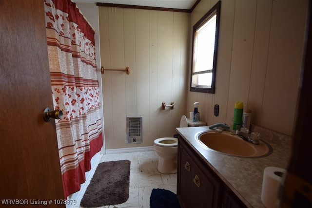 bathroom with heating unit, vanity, a shower with curtain, and toilet