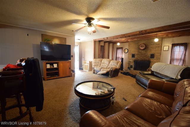 living room featuring ceiling fan, a fireplace, carpet, and a textured ceiling