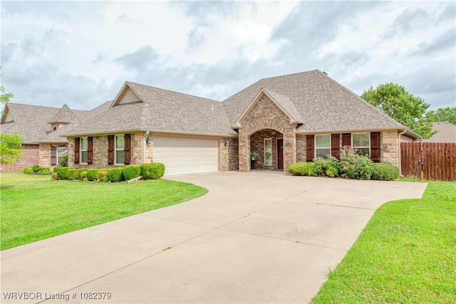 5707 Callaway Ln, Fort Smith, AR 72916 - view of front of house featuring roof with shingles, concrete driveway, an attached garage, stone siding, and brick siding