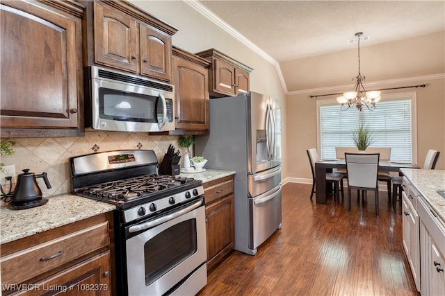 5707 Callaway Ln, Fort Smith, AR 72916 - kitchen with appliances with stainless steel finishes, a chandelier, lofted ceiling, dark wood-type flooring, and tasteful backsplash