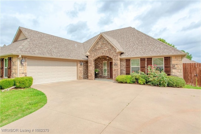5707 Callaway Ln, Fort Smith, AR 72916 - view of front of property featuring roof with shingles, driveway, a garage, stone siding, and brick siding