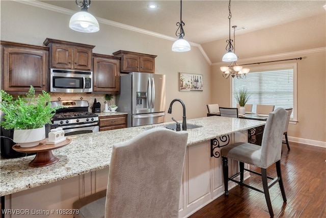 5707 Callaway Ln, Fort Smith, AR 72916 - kitchen featuring stainless steel appliances, a breakfast bar area, dark wood finished floors, tasteful backsplash, and light stone countertops