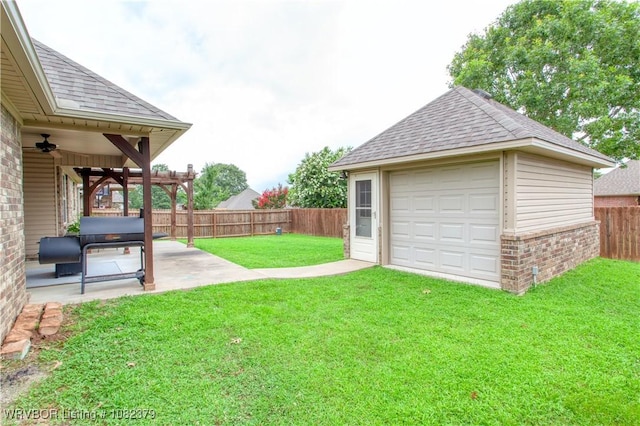 5707 Callaway Ln, Fort Smith, AR 72916 - fenced backyard with a garage, a patio area, ceiling fan, driveway, and an outbuilding