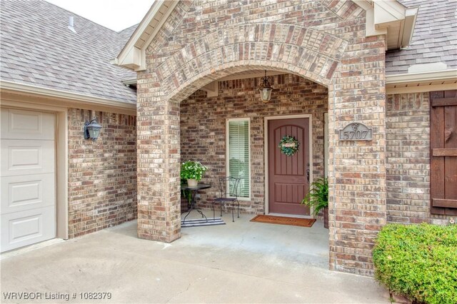5707 Callaway Ln, Fort Smith, AR 72916 - doorway to property featuring a shingled roof and brick siding