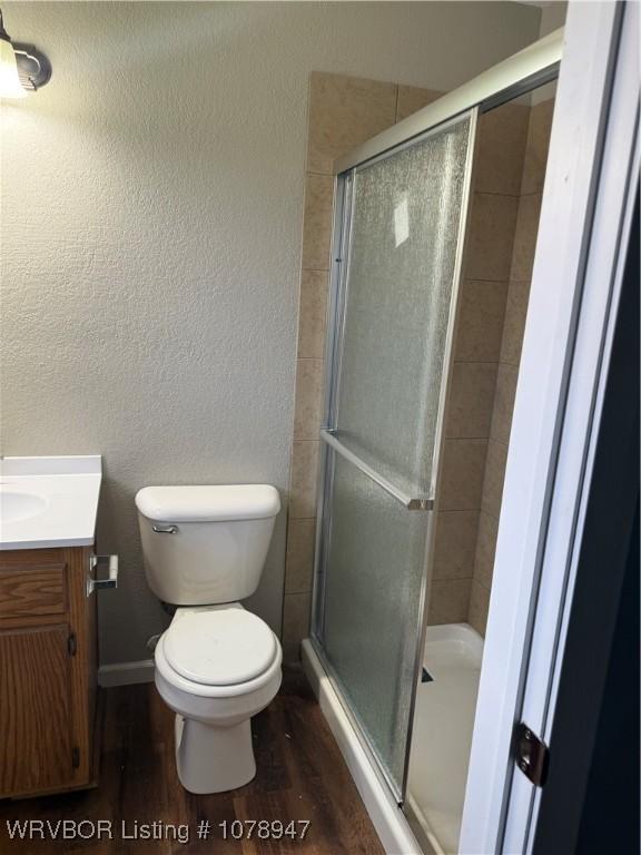 1709 Z St, Fort Smith, AR 72901 - bathroom featuring toilet, vanity, a stall shower, and wood finished floors