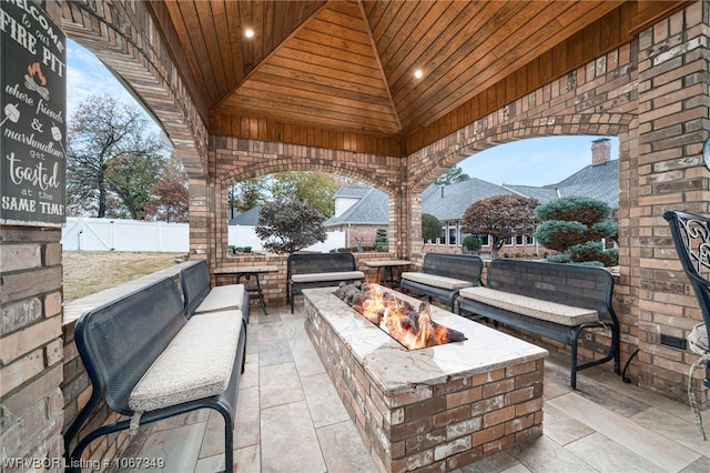 view of patio / terrace with a gazebo, a mountain view, and a fire pit