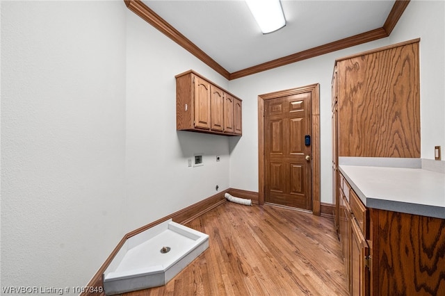 clothes washing area featuring cabinets, washer hookup, crown molding, and hookup for an electric dryer