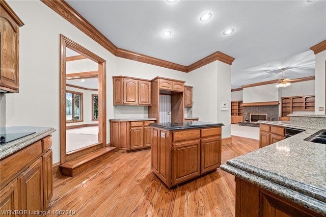 kitchen with a center island, light hardwood / wood-style flooring, and ornamental molding