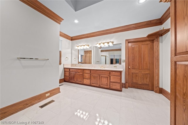 bathroom featuring crown molding, tile patterned flooring, and vanity