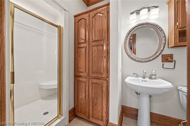 bathroom featuring tile patterned flooring, a shower with shower door, and sink