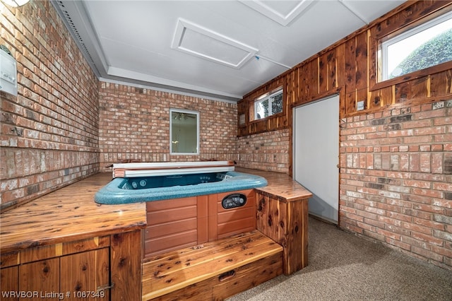 interior space featuring carpet and brick wall