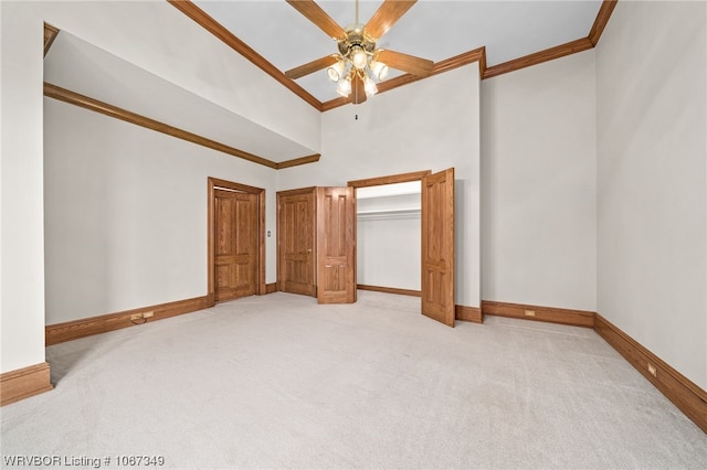 unfurnished bedroom with ceiling fan, crown molding, high vaulted ceiling, and light colored carpet