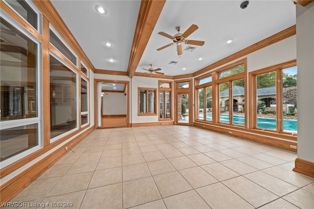 unfurnished sunroom featuring ceiling fan and beamed ceiling