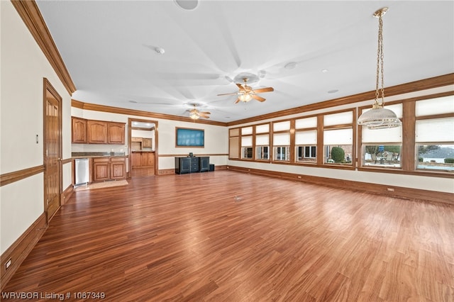 unfurnished living room featuring hardwood / wood-style flooring, ceiling fan, and ornamental molding