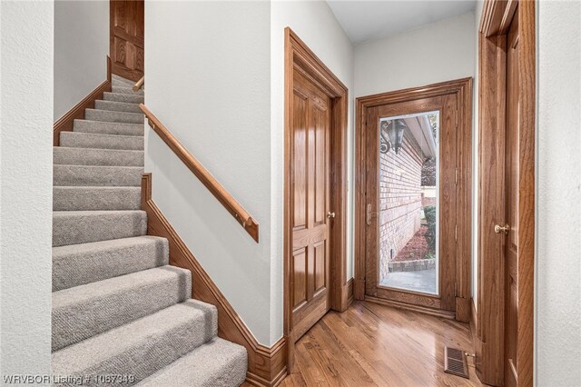 doorway with light wood-type flooring