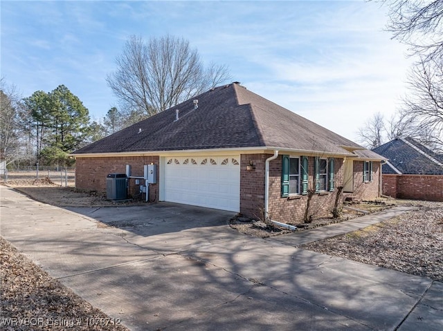 view of property exterior with a garage and central air condition unit