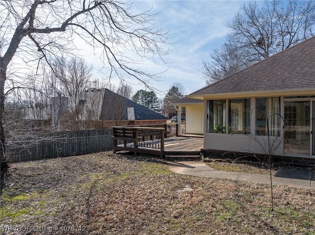 view of yard with a sunroom and a deck