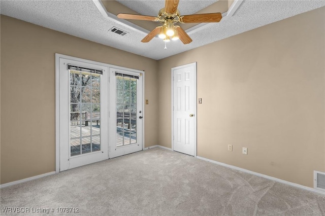 carpeted spare room with ceiling fan and a textured ceiling