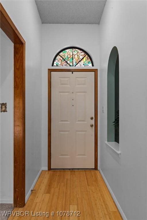 doorway to outside with light wood-type flooring