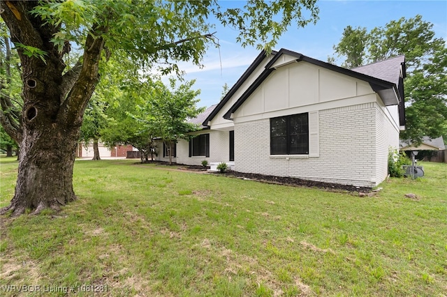 8901 Royal Ridge Dr, Fort Smith, AR 72903 - view of side of property featuring brick siding, a yard, and board and batten siding