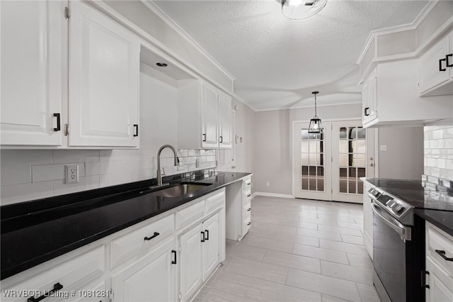 8901 Royal Ridge Dr, Fort Smith, AR 72903 - kitchen featuring a sink, electric range, dark countertops, tasteful backsplash, and white cabinetry