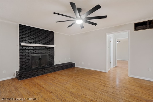 8901 Royal Ridge Dr, Fort Smith, AR 72903 - unfurnished living room featuring ceiling fan, a brick fireplace, wood finished floors, baseboards, and crown molding