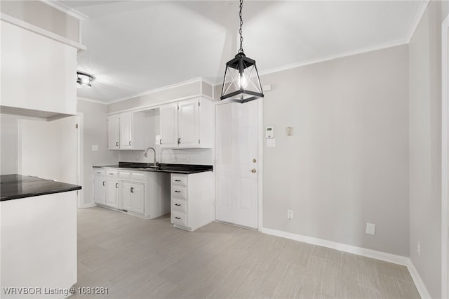 8901 Royal Ridge Dr, Fort Smith, AR 72903 - kitchen featuring ornamental molding, white cabinetry, dark countertops, baseboards, and a sink