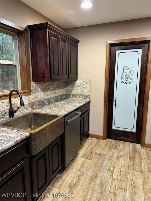 185 Susie Ln, Mena, AR 71953 - kitchen with dishwasher, sink, light stone countertops, light wood-type flooring, and tasteful backsplash