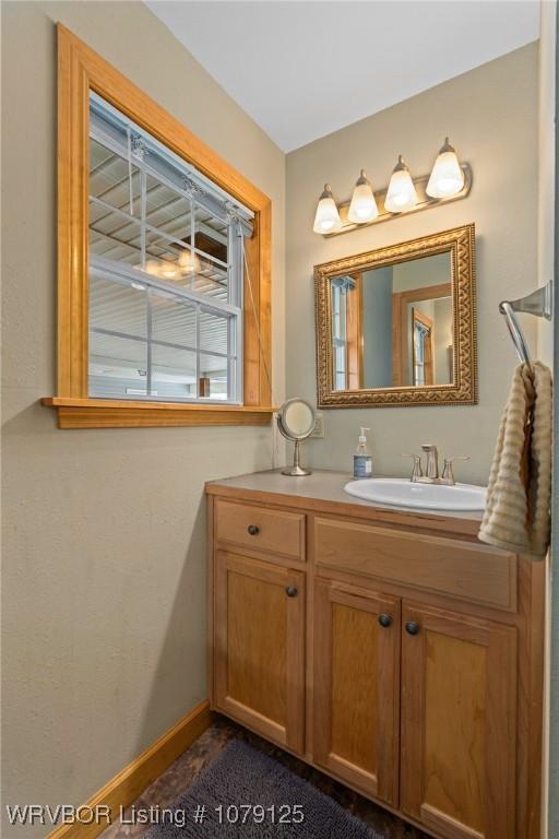 bathroom with vanity and baseboards