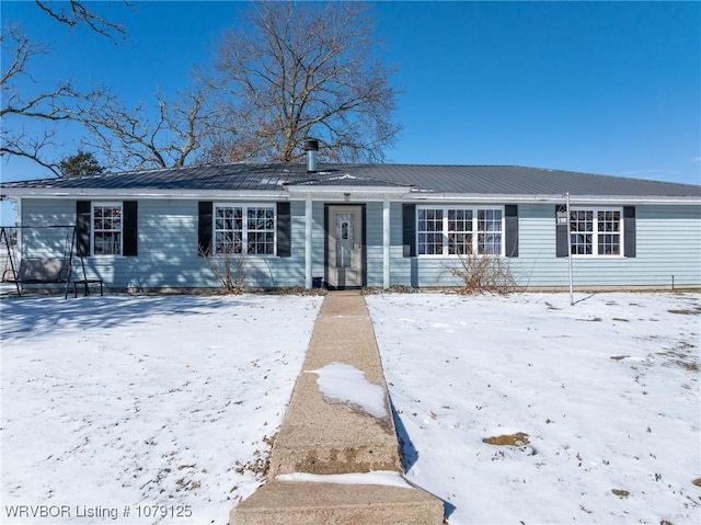 single story home with metal roof