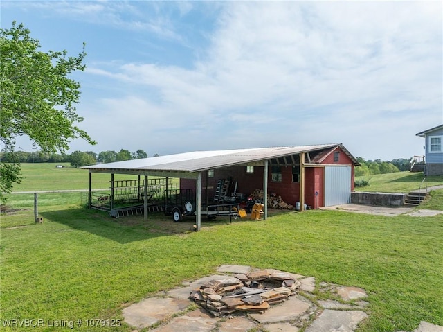 255 Spielerville Rd, Paris, AR 72855 - view of pole building with a fire pit, fence, a carport, and a yard