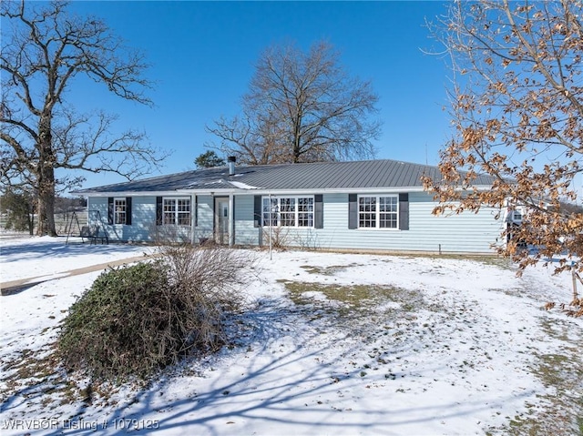 single story home with metal roof