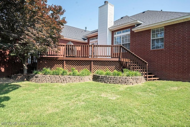 1129 Arapahoe Dr, Van Buren, AR 72956 - back of property featuring a deck, a shingled roof, a lawn, and a chimney