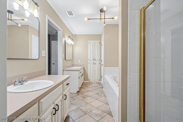 1129 Arapahoe Dr, Van Buren, AR 72956 - bathroom featuring two vanities, a garden tub, tile patterned flooring, and tiled shower