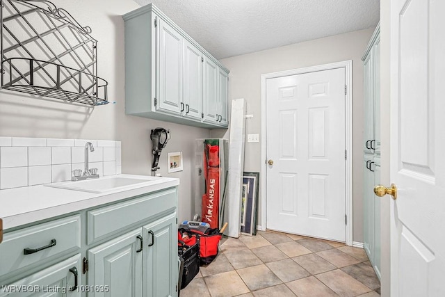 1129 Arapahoe Dr, Van Buren, AR 72956 - washroom featuring washer hookup, cabinet space, and a textured ceiling