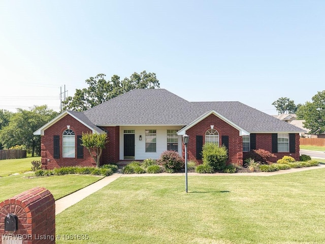 1129 Arapahoe Dr, Van Buren, AR 72956 - view of front facade featuring brick siding, a front yard, and a shingled roof