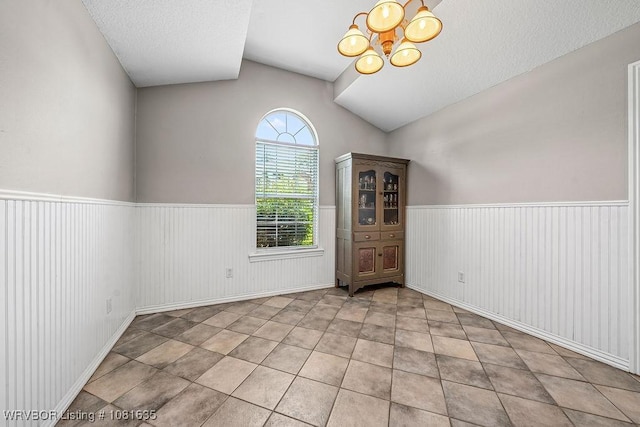 1129 Arapahoe Dr, Van Buren, AR 72956 - unfurnished room with wainscoting, vaulted ceiling, and a chandelier