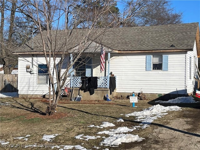 view of snow covered rear of property