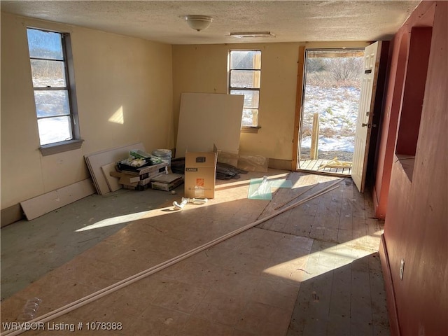 unfurnished room featuring a textured ceiling