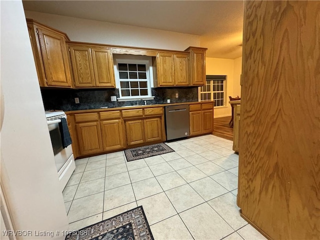 kitchen with dishwasher, backsplash, sink, light tile patterned floors, and white electric range oven