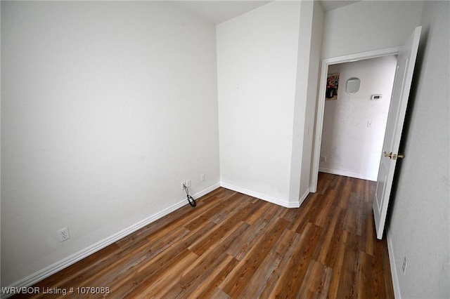 empty room featuring dark wood-type flooring