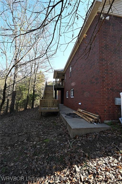 view of property exterior with a patio area