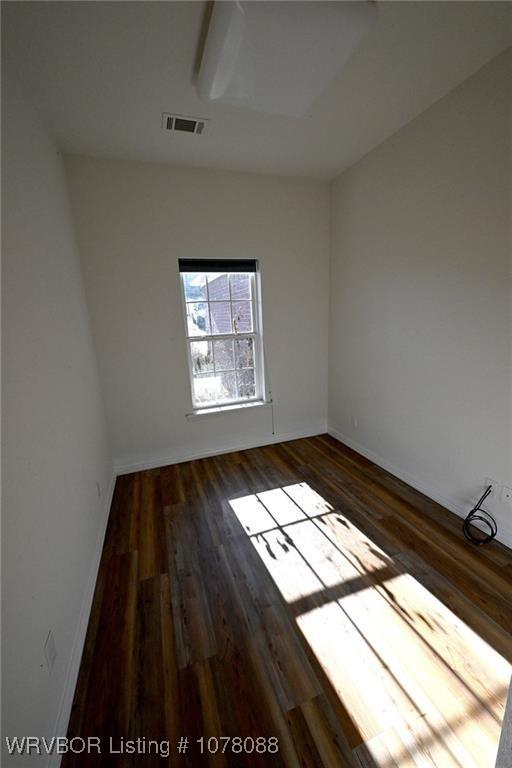 empty room featuring dark wood-type flooring